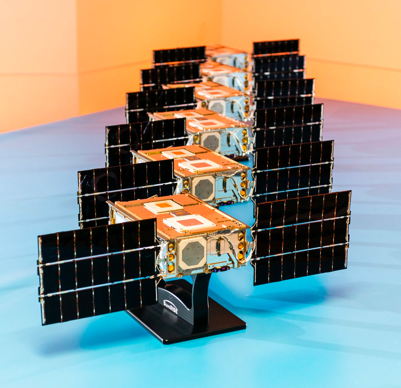 The SunRISE mission comprises six satellites, each compacted to the size of a cereal box and equipped with small solar panels. These SmallSats collaboratively form an innovative approach, effectively simulating a significantly larger radio antenna in space. Image credit: Space Dynamics Laboratory/Allison Bills.